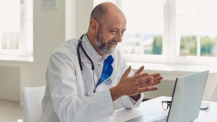 A physician dictates a clinical note using ambient voice technology