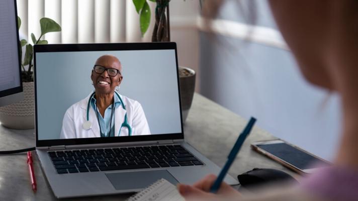A doctor consulting with a patient via telehealth