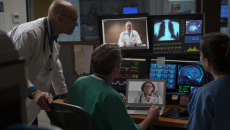Medical professionals examine screens